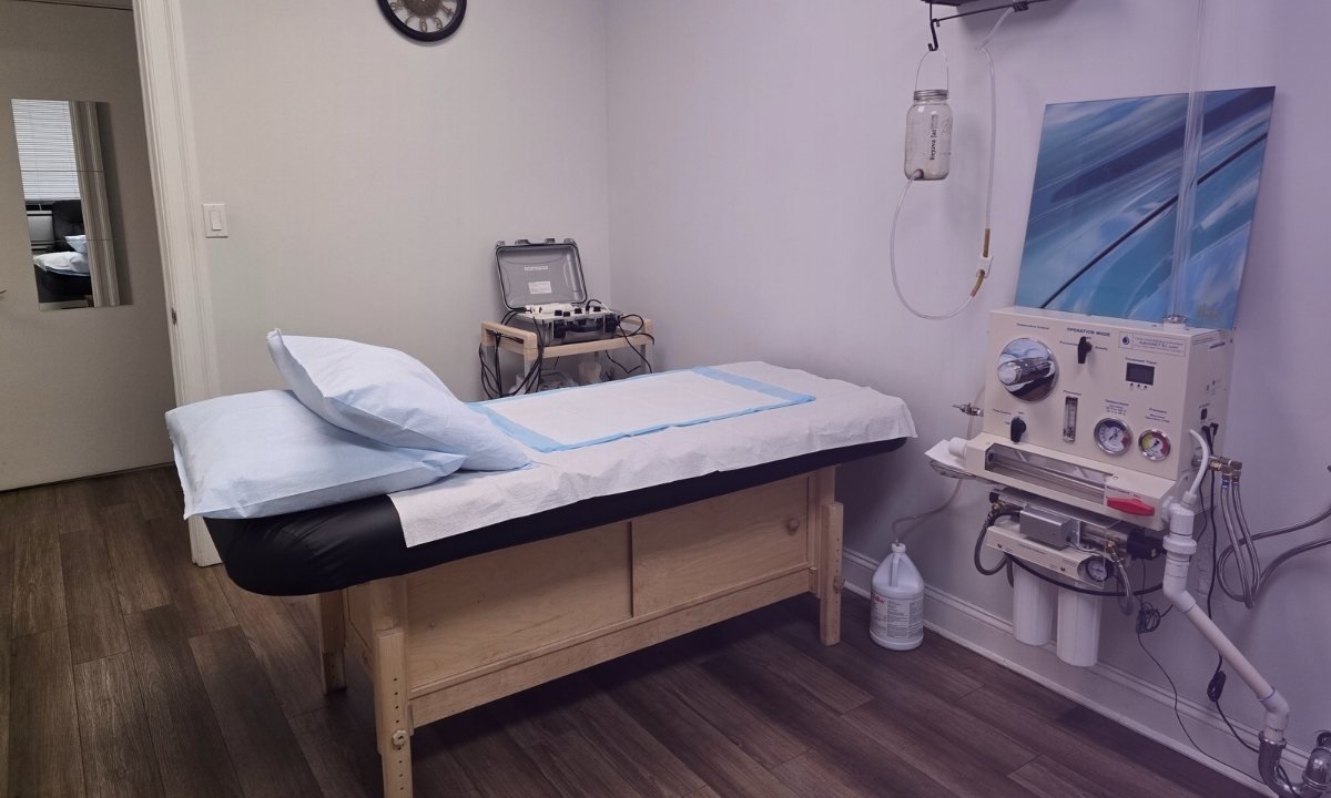Colon hydrotherapy session room in NYC wellness center with modern colonic equipment and calming clinical setting